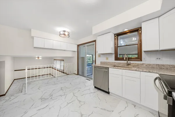 a view of a hallway with a large window and a rug