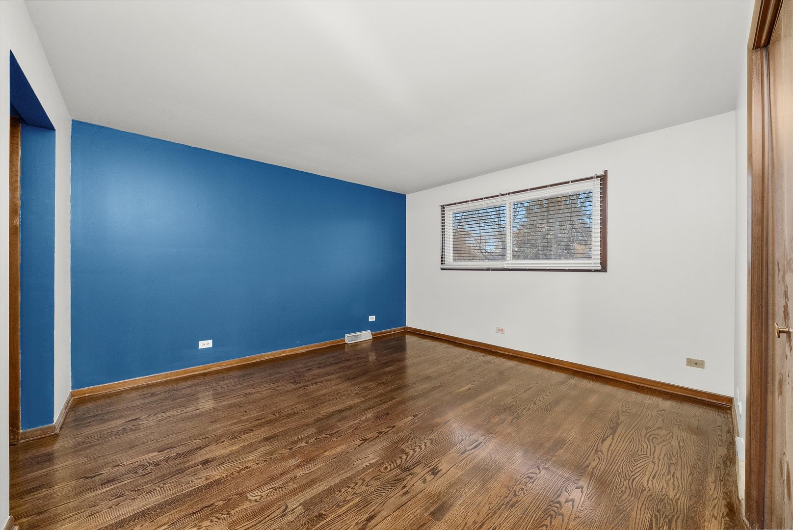 17731 Larkspur Lane Homewood, IL 60430 - Photo 17 of 38 a view of an empty room with wooden floor and a window
