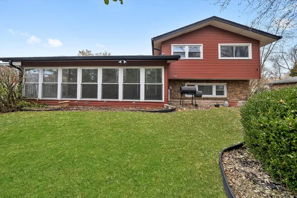 a view of a house with a yard and tree s