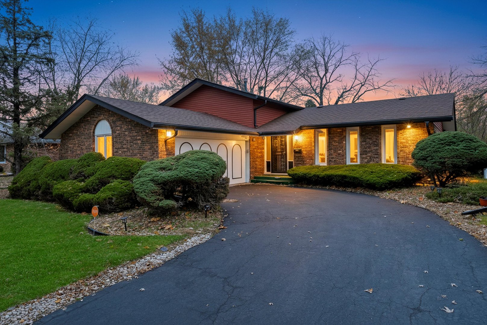 17731 Larkspur Lane Homewood, IL 60430 - Photo 35 of 38 a front view of a house with a garden and trees
