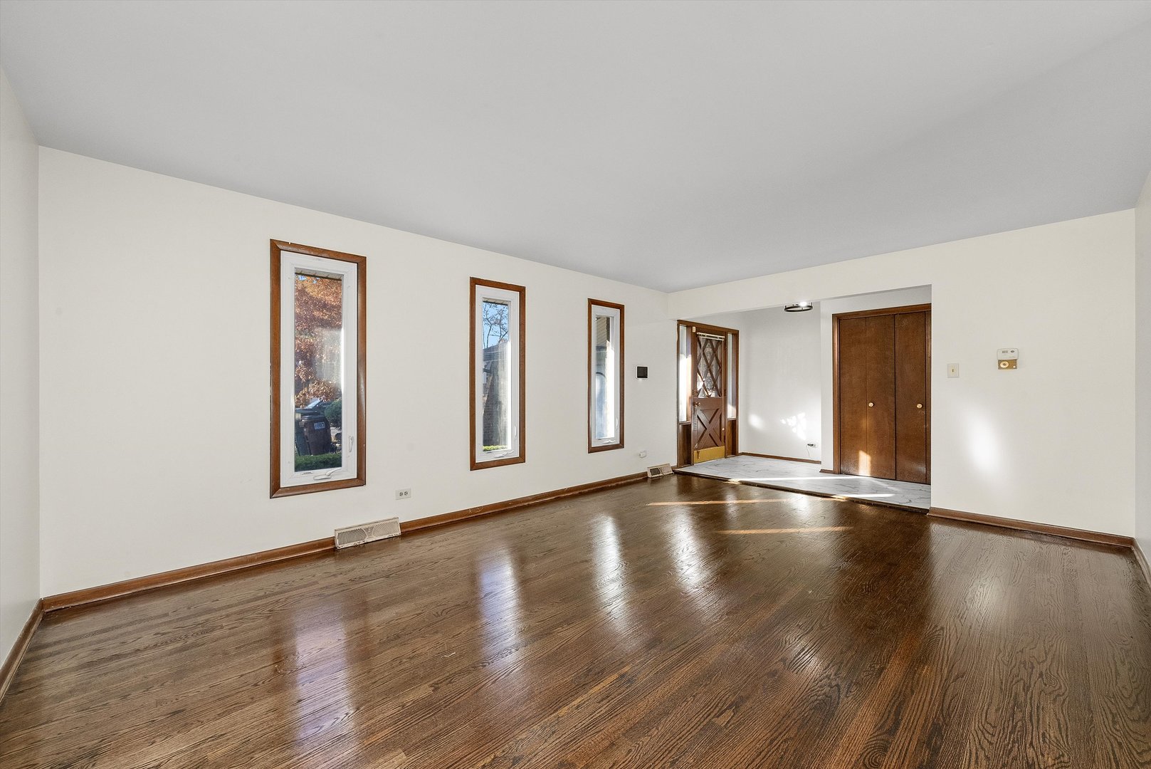 17731 Larkspur Lane Homewood, IL 60430 - Photo 5 of 38 a view of an empty room with wooden floor and window
