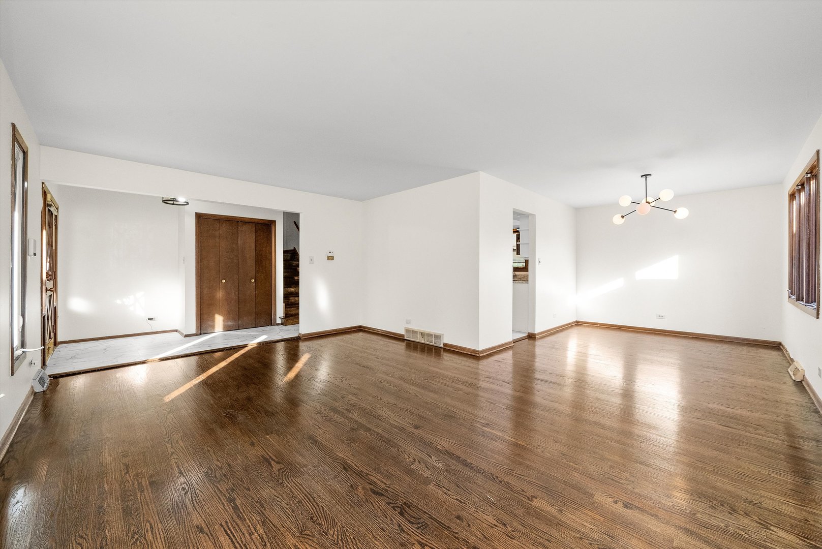 17731 Larkspur Lane Homewood, IL 60430 - Photo 6 of 38 an empty room with wooden floor and windows
