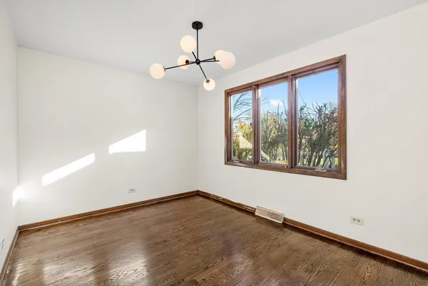 a kitchen with granite countertop a refrigerator and a stove top oven