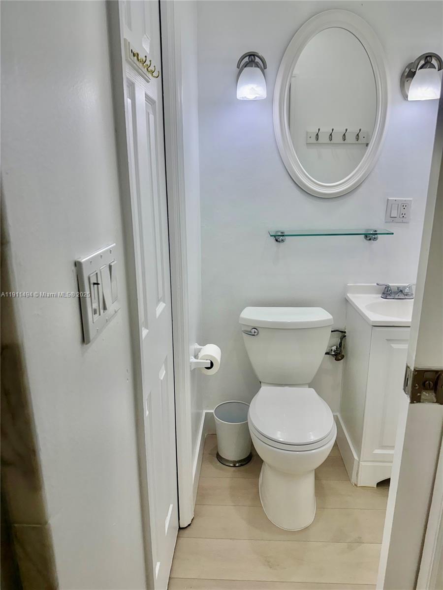 13008 Southwest 50th Lane, Unit 13008 Miami, FL 33175 - Photo 12 of 12 a bathroom with a toilet and a mirror