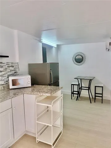 a kitchen that has a cabinets and a table in it