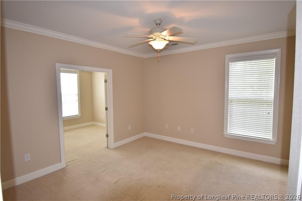 159 Gallery Drive, Unit 201 Spring Lake, NC 28390 - Photo 13 of 18 en empty room with windows and chandelier fan