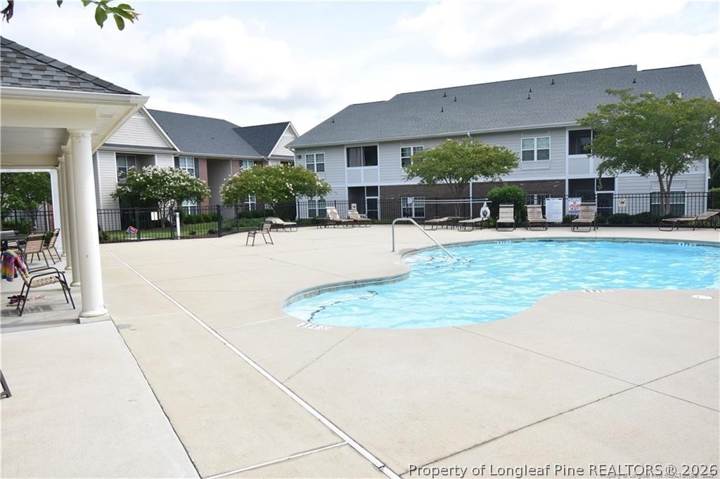 159 Gallery Drive, Unit 201 Spring Lake, NC 28390 - Photo 16 of 18 a swimming pool with outdoor seating yard and porch