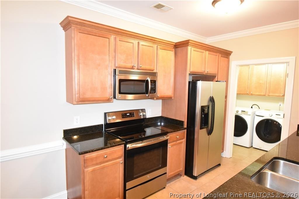 159 Gallery Drive, Unit 201 Spring Lake, NC 28390 - Photo 2 of 18 a kitchen with stainless steel appliances a stove microwave and a refrigerator