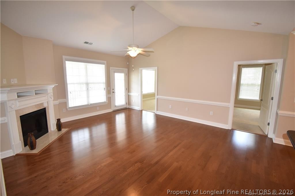 159 Gallery Drive, Unit 201 Spring Lake, NC 28390 - Photo 7 of 18 an empty room with wooden floor fireplace and windows