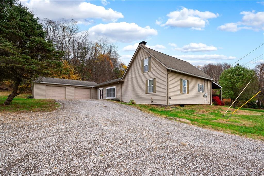 a view of a house with backyard and trees