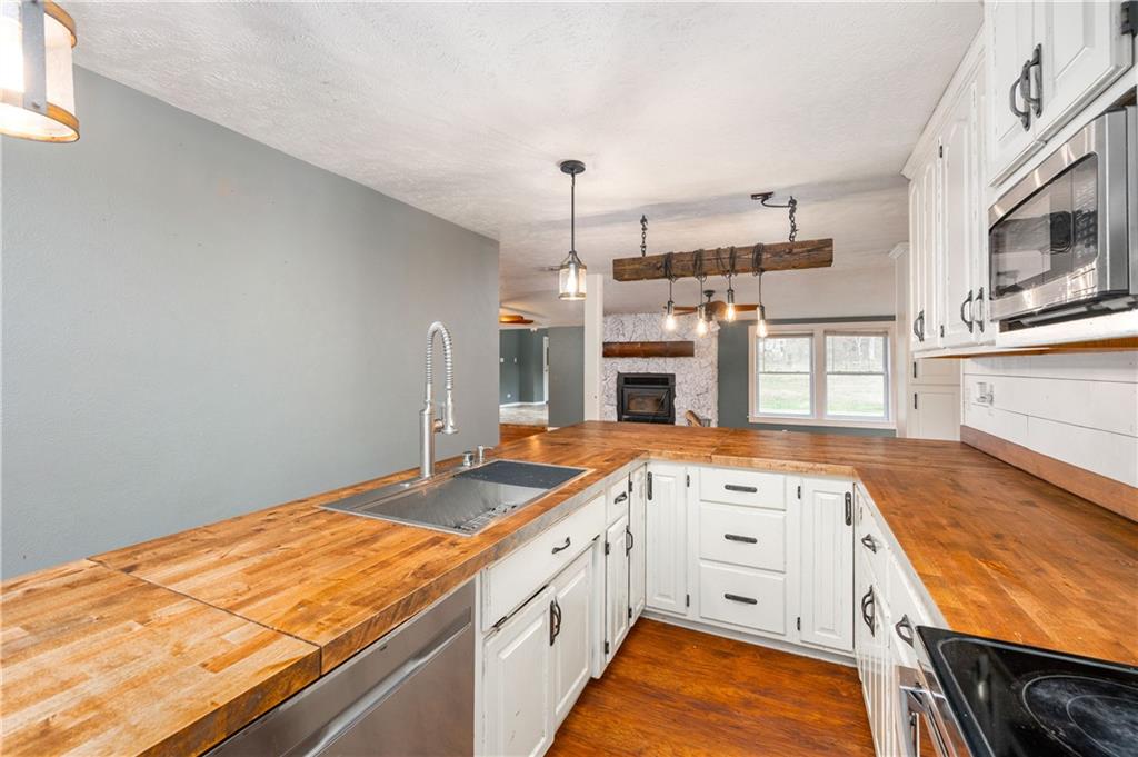 172 Queen Junction Road Butler, PA 16001 - Photo 17 of 35 a kitchen with a stove a sink and a refrigerator