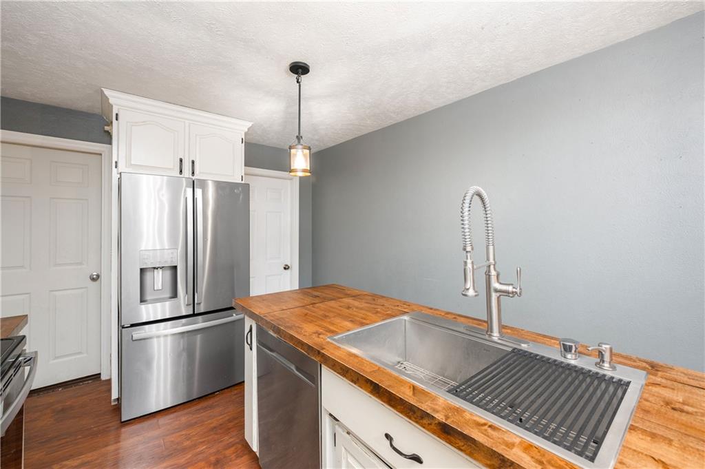 172 Queen Junction Road Butler, PA 16001 - Photo 18 of 35 a kitchen with kitchen island a counter top space cabinets and stainless steel appliances