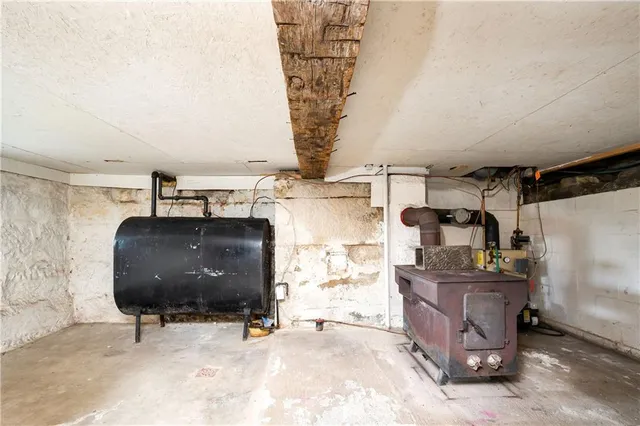 a room with kitchen island stainless steel appliances a stove a sink and a refrigerator