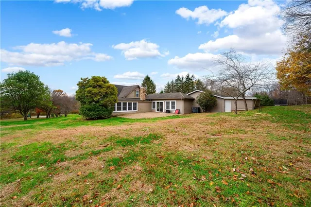 a house view with swimming pool in front of the house