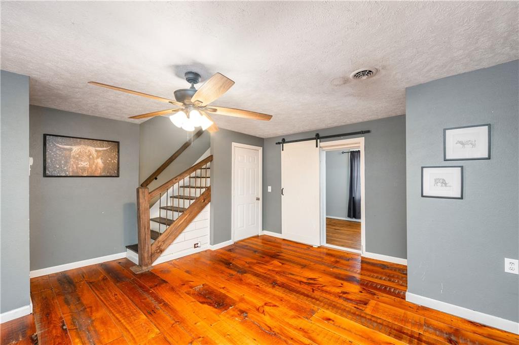 172 Queen Junction Road Butler, PA 16001 - Photo 6 of 35 a bedroom with a bed and a chandelier