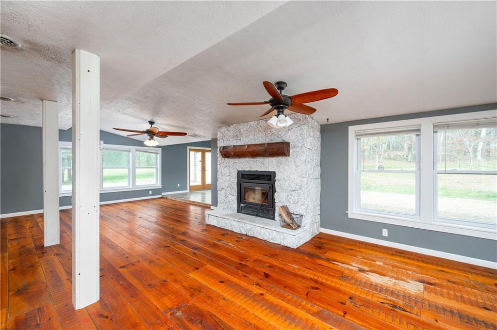 172 Queen Junction Road Butler, PA 16001 - Photo 9 of 35 a view of an empty room with wooden floor fireplace and a window