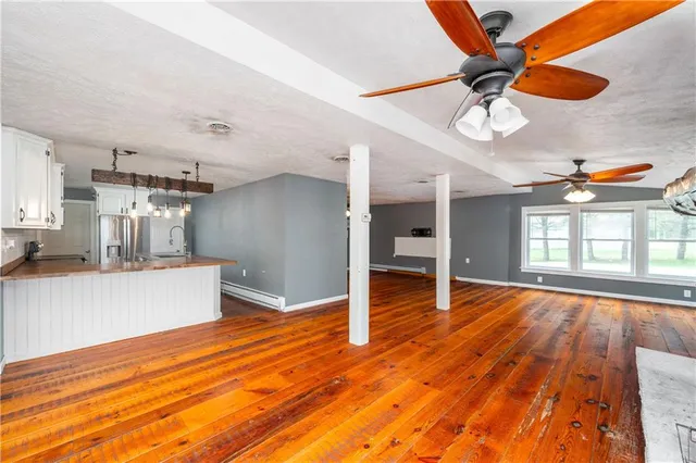 a view of a room with wooden floor and windows