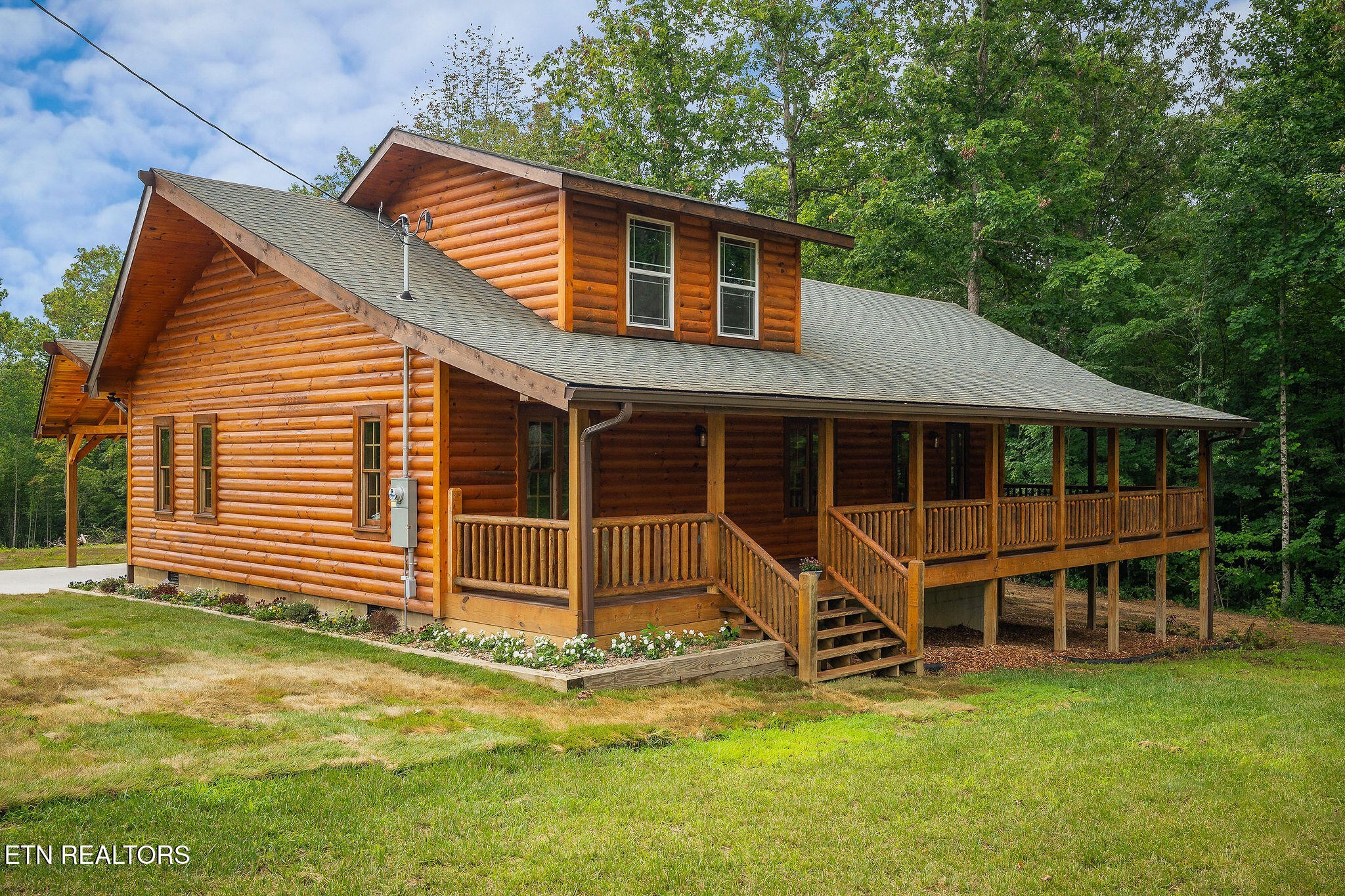 a view of house with backyard and balcony