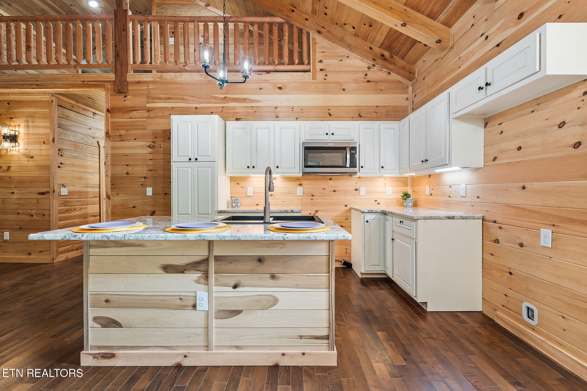 106 Raccoon Lane Jamestown, TN 38556 - Photo 15 of 38 a kitchen with kitchen island granite countertop a stove top oven a sink and dishwasher with white cabinets