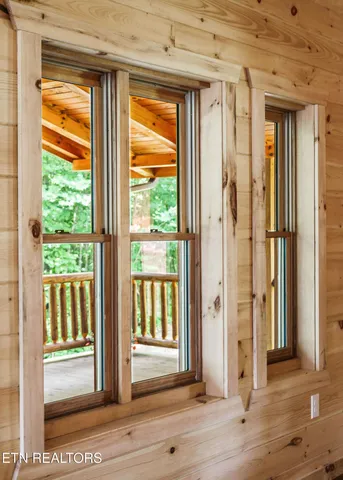 a view of a bathroom with a window and wooden floor
