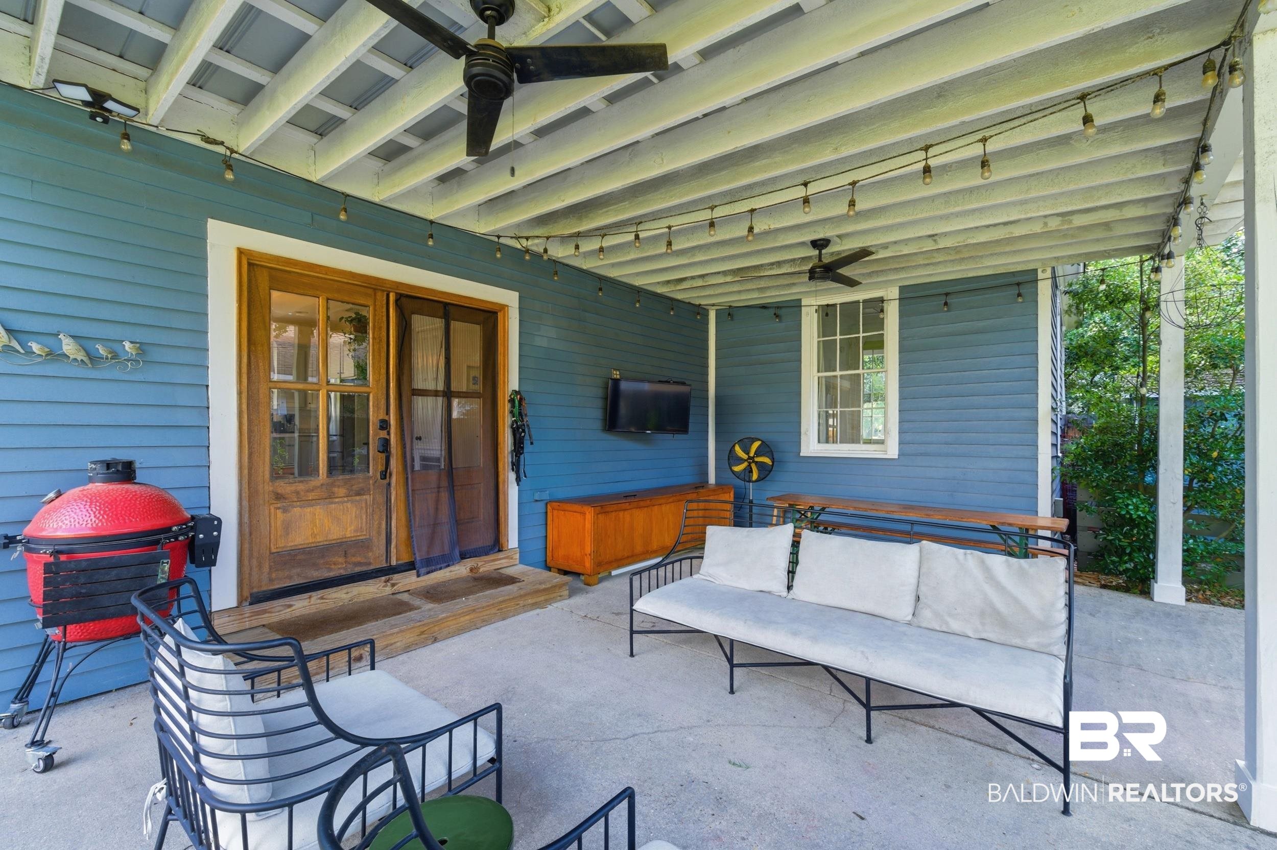 350 Charles Street Mobile, AL 36604 - Photo 30 of 52 Covered patio featuring a concrete slab, dual ceiling fans, and string lighting