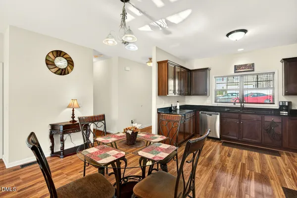 a view of a dining room with furniture and wooden floor