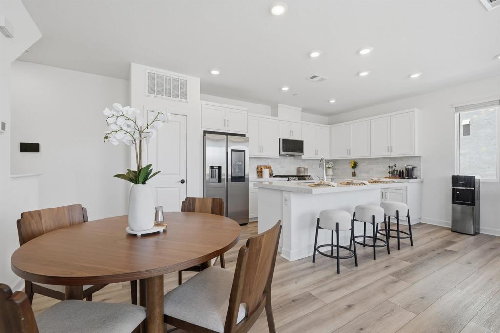 2402 Cascalote Loop San Diego, CA 92154 - Photo 10 of 35 a kitchen with kitchen island a dining table and chairs