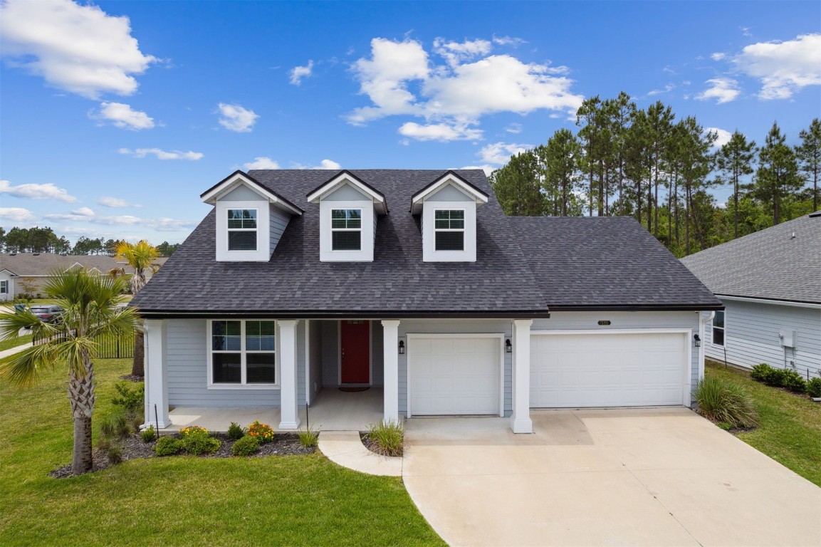 75251 White Rabbit Avenue Yulee, FL 32097 - Photo 1 of 83 a front view of a house with a yard