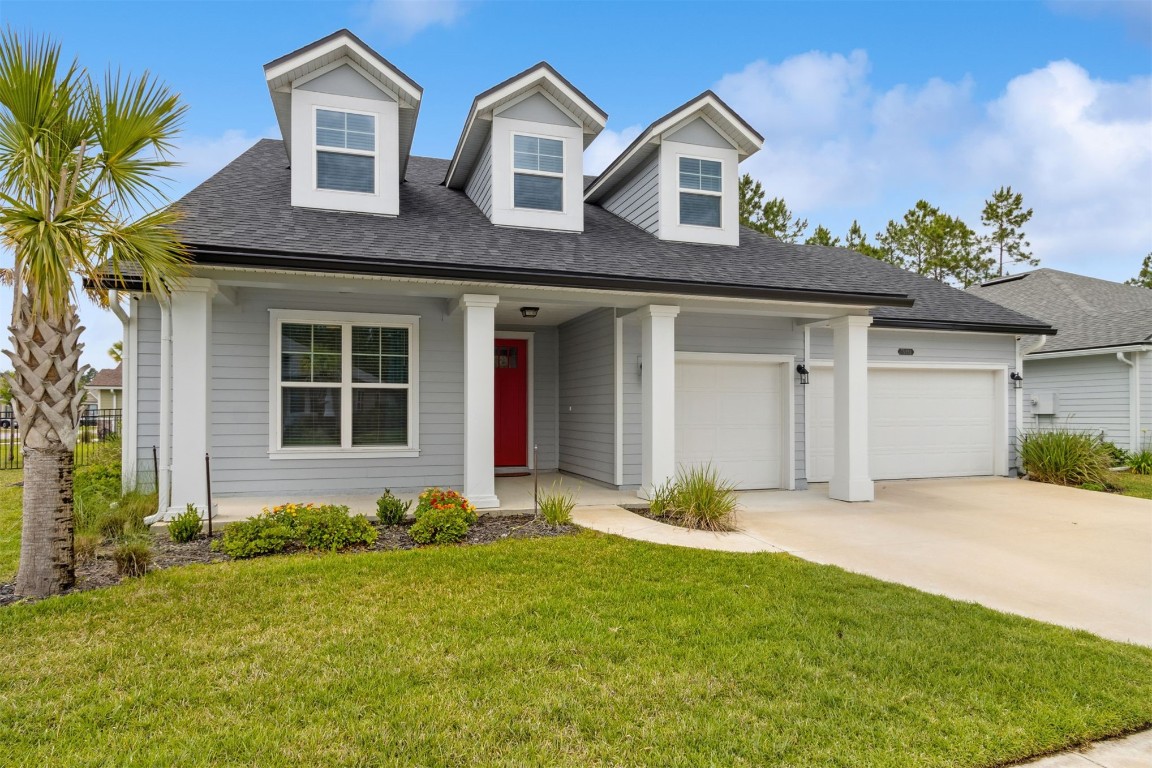75251 White Rabbit Avenue Yulee, FL 32097 - Photo 11 of 83 a front view of a house with a yard and garage