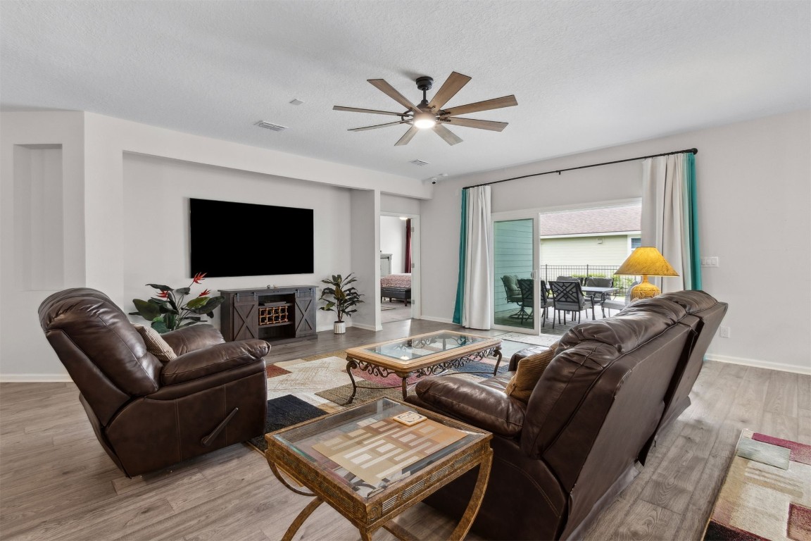 75251 White Rabbit Avenue Yulee, FL 32097 - Photo 15 of 83 a living room with furniture a flat screen tv and a large window