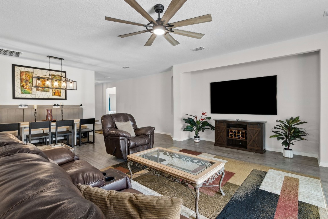 75251 White Rabbit Avenue Yulee, FL 32097 - Photo 2 of 83 a living room with furniture a flat screen tv and a fireplace