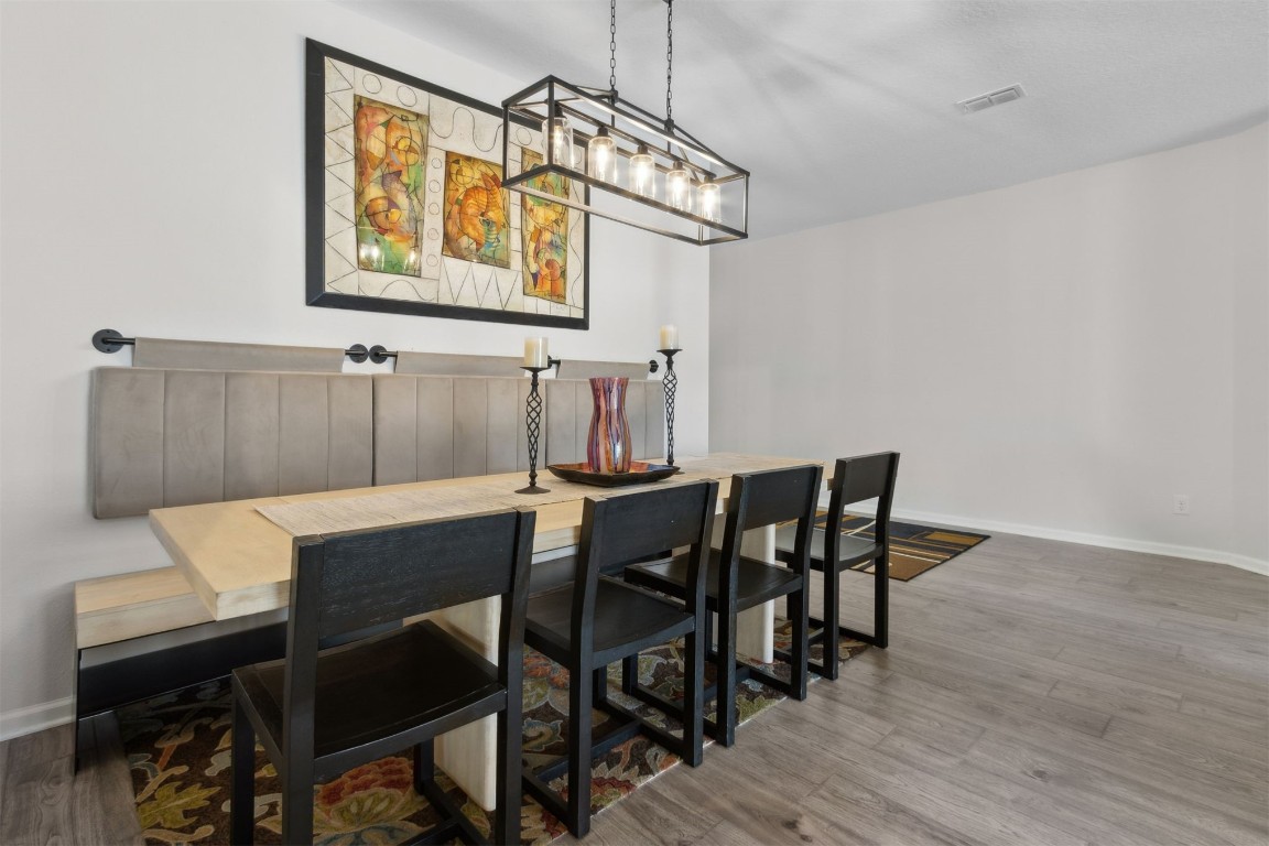 75251 White Rabbit Avenue Yulee, FL 32097 - Photo 23 of 83 a view of a dining room with furniture and wooden floor