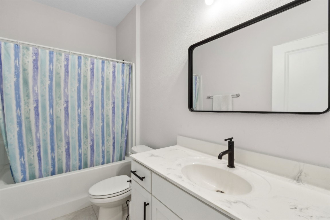 75251 White Rabbit Avenue Yulee, FL 32097 - Photo 29 of 83 a bathroom with a sink a toilet and mirror