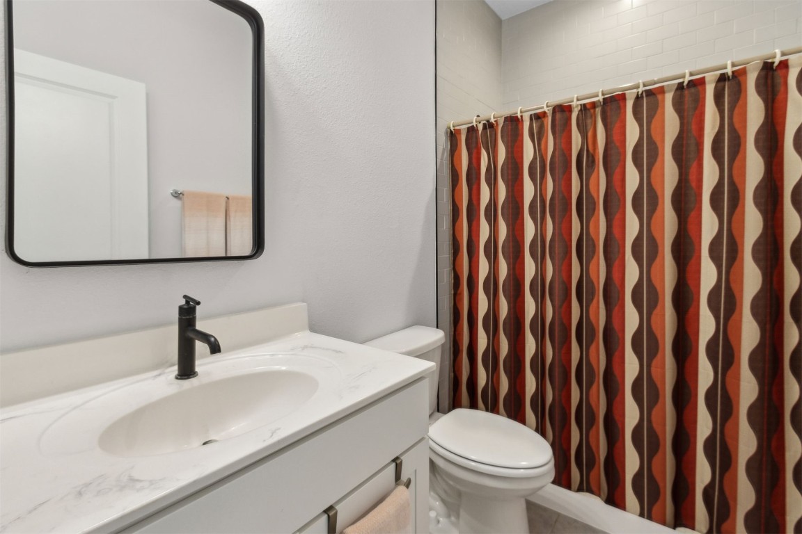 75251 White Rabbit Avenue Yulee, FL 32097 - Photo 32 of 83 a bathroom with a sink a toilet and mirror