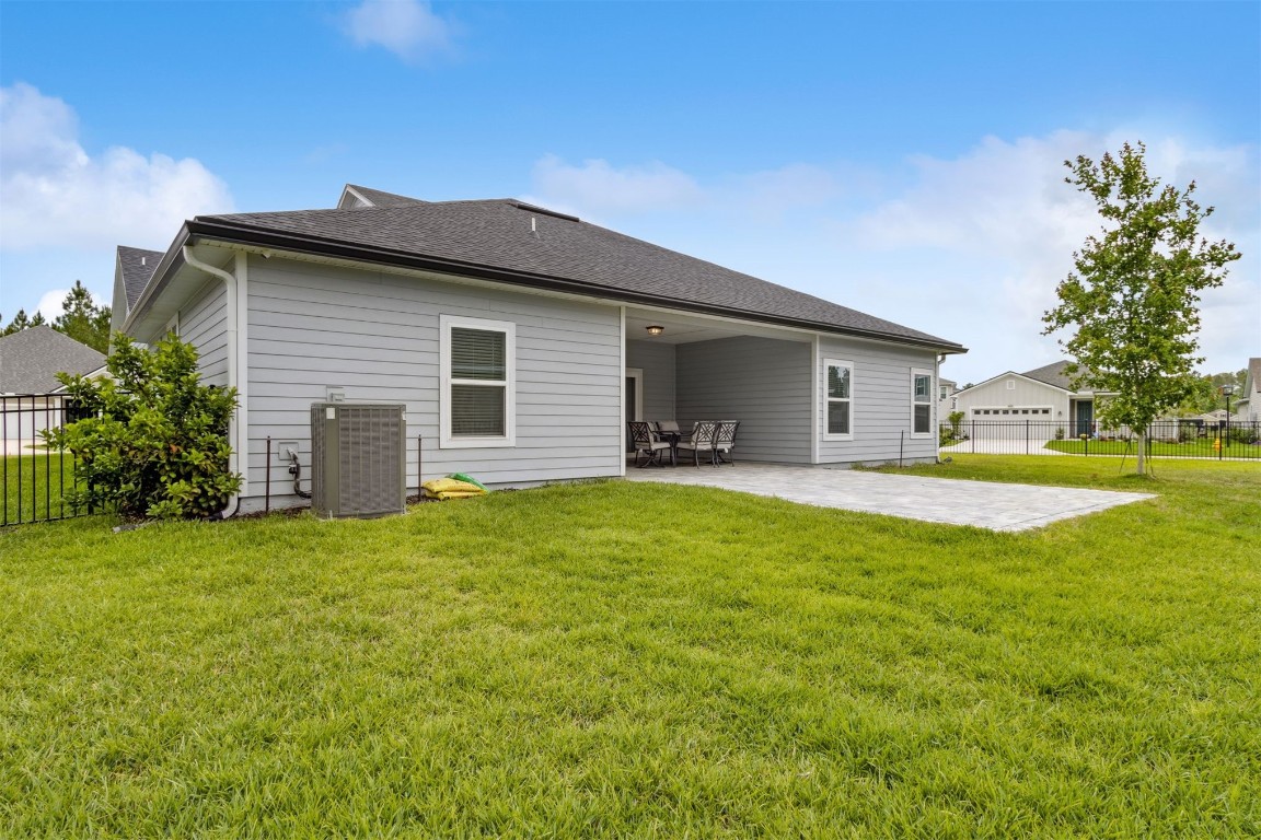 75251 White Rabbit Avenue Yulee, FL 32097 - Photo 41 of 83 a front view of house with yard and green space