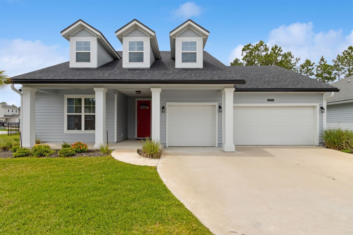 75251 White Rabbit Avenue Yulee, FL 32097 - Photo 10 of 83 a front view of a house with a yard and garage