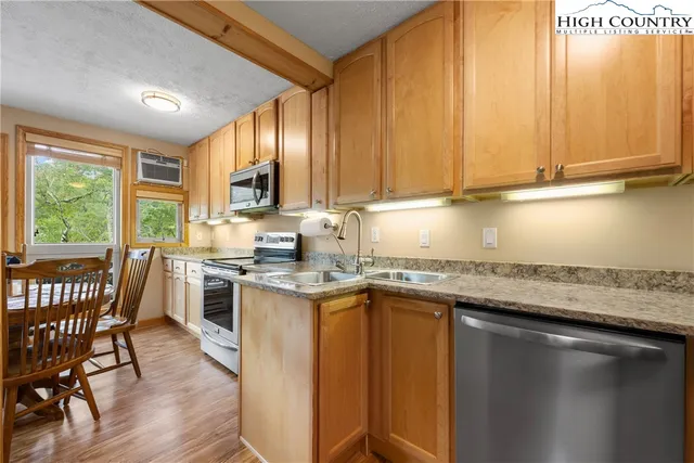 a spacious bedroom with a bed and a flat screen tv