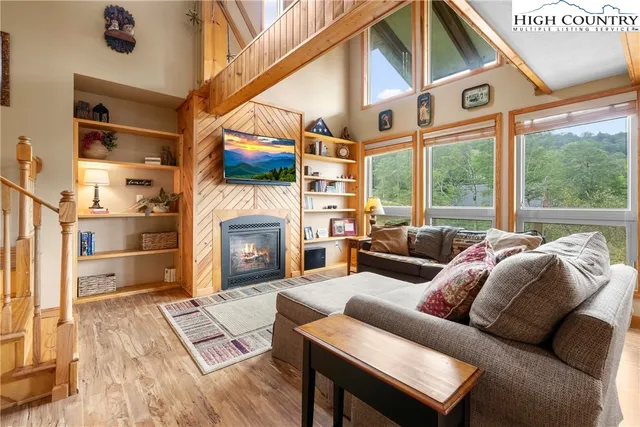 a living room with furniture and a chandelier