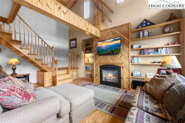 a living room with lots of furniture and wooden floors