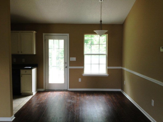 305 Autumn Ridge Trail Gray, GA 31032 - Photo 2 of 9 a view of an empty room with wooden floor and a window