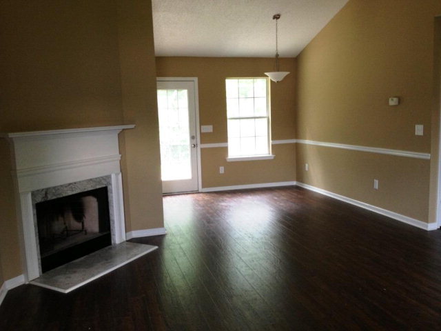 305 Autumn Ridge Trail Gray, GA 31032 - Photo 3 of 9 a view of wooden floor fire place and windows in a room