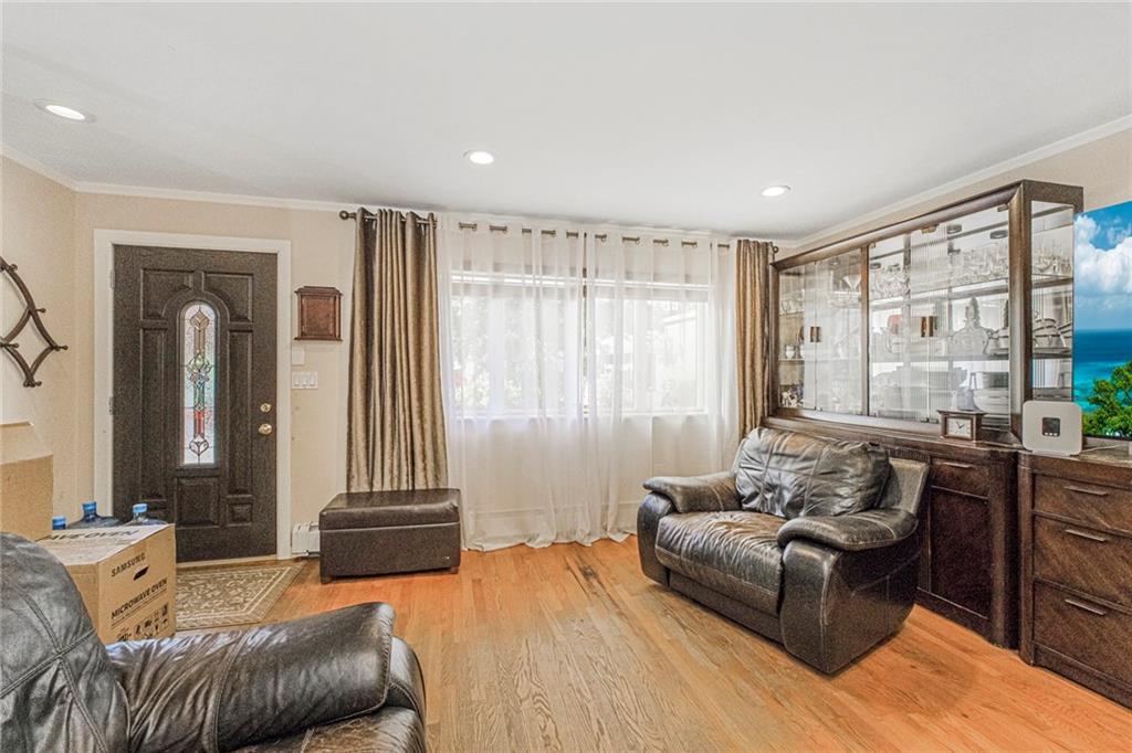 2809 East 28th Street, Unit 1C Brooklyn, NY 11235 - Photo 11 of 38 a living room with furniture and a large window