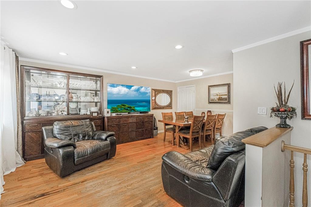 2809 East 28th Street, Unit 1C Brooklyn, NY 11235 - Photo 12 of 38 a living room with furniture and a large window