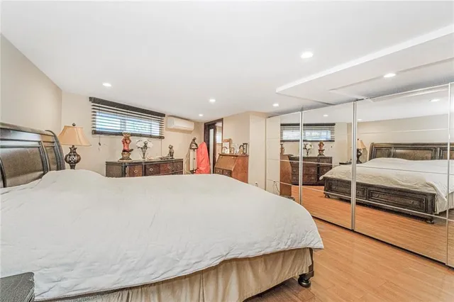 a spacious bedroom with a bed and a large window