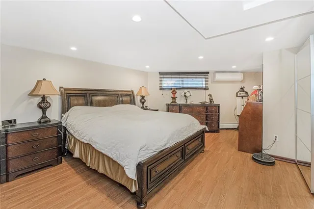 a living room with furniture hard wood floor and a flat screen tv