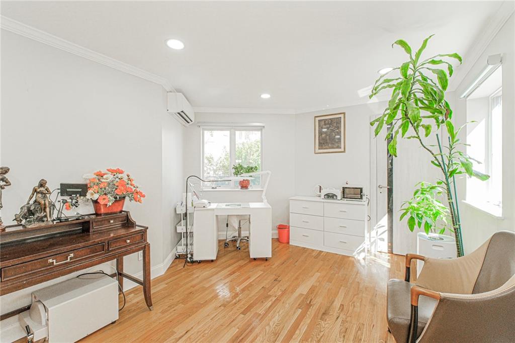 2809 East 28th Street, Unit 1C Brooklyn, NY 11235 - Photo 26 of 38 a room with furniture and a potted plant