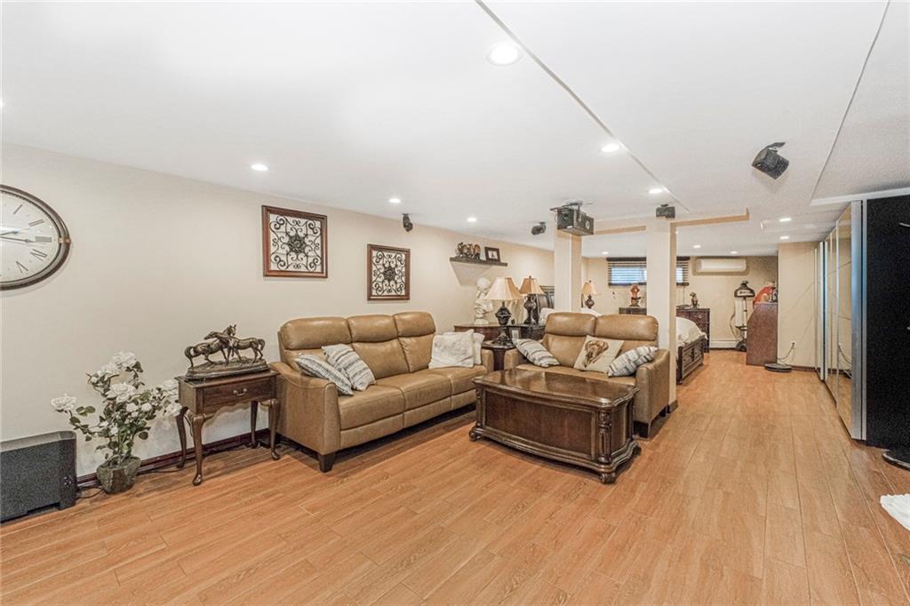 2809 East 28th Street, Unit 1C Brooklyn, NY 11235 - Photo 30 of 38 a living room with furniture and a flat screen tv