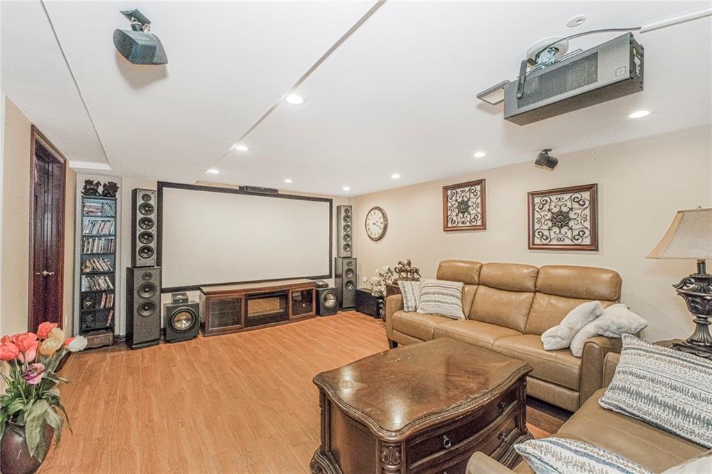 2809 East 28th Street, Unit 1C Brooklyn, NY 11235 - Photo 35 of 38 a living room with furniture a projector and a table