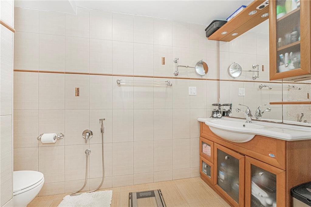 2809 East 28th Street, Unit 1C Brooklyn, NY 11235 - Photo 38 of 38 a bathroom with a sink a toilet and shower