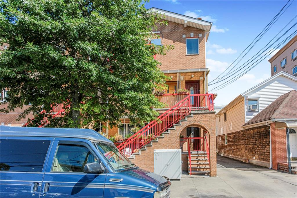 2809 East 28th Street, Unit 1C Brooklyn, NY 11235 - Photo 5 of 38 a front view of a house with a yard